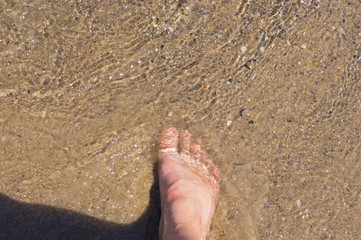 High angle of female foot in sea water