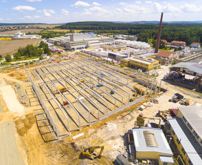Aerial view of industrial zone with new construction site. Industry, development and investment in European Union. - Powered by Adobe