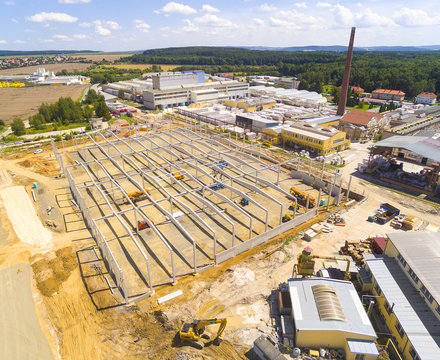Aerial view of industrial zone with new construction site. Industry, development and investment in European Union.