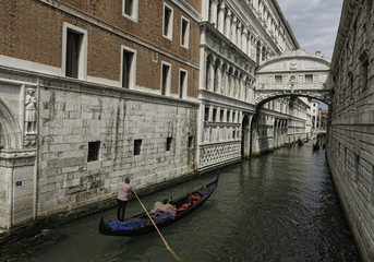 Fototapeta na wymiar Gondola in Venice - The stunningly old buildings along a canal in Venice, Italy