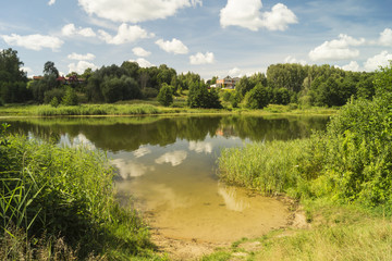 Fototapeta na wymiar Year landscape with river on background blue sky