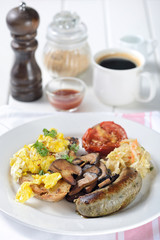 English breakfast with egg, sausage, vegetable, mushrooms, bread and tomato.