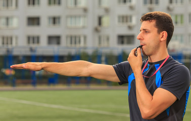 referee blows the whistle