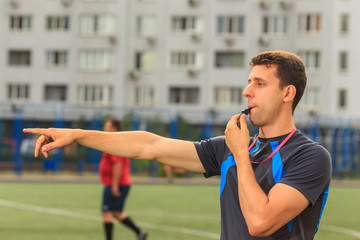 referee blows the whistle