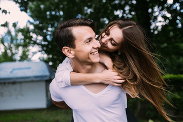 Fototapeta premium Young adult brunette man and woman in the park