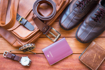 Men's casual outfits with leather accessories on wooden background