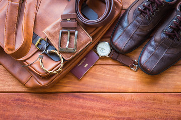 Men's casual outfits with leather accessories on wooden background