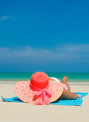 Fototapeta na wymiar Fit woman in sun hat and bikini at beach