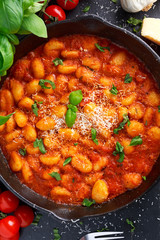 Homemade Italian Gnocchi with marinara sauce, cheese in iron pan