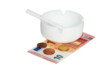 White ashtray with cigarette, euros banknotes and coins on the white background.