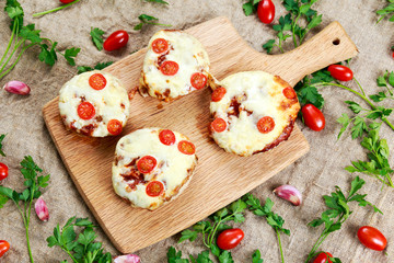 Cooked Mushrooms stuffed with cheese and plum tomatoes.