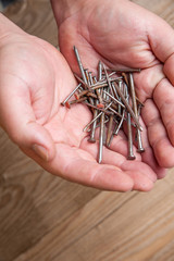 Workman holding nails