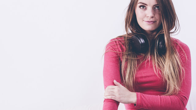 Young lady wearing headphones.