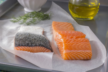 Raw Salmon Fillets on Wax Paper with Baking Sheet