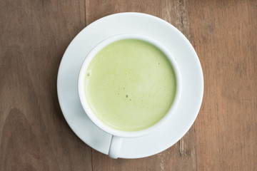 green tea latte on wood background