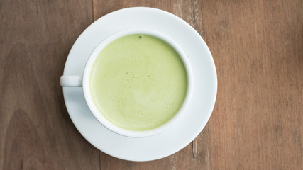 green tea latte on wood background