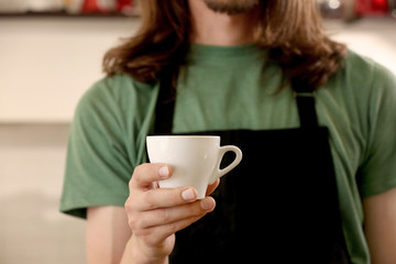 Man holding cup of coffee