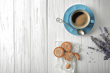 Lavender with coffee and cookies on wooden background