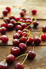 Fresh ripe cherries on wooden background