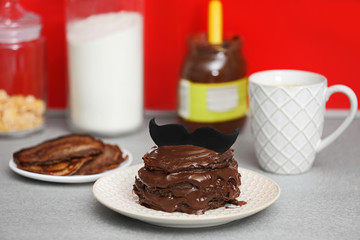 Chocolate pancakes with mustache on table. Happy fathers day concept