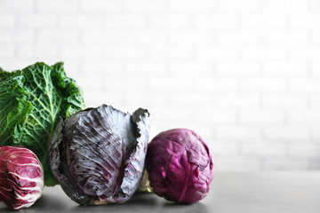 Different kinds of cabbage on brick wall background