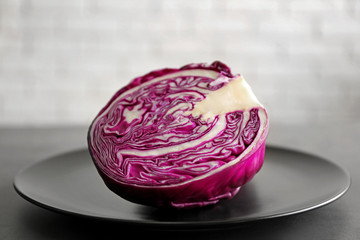 Red cabbage on plate, brick wall background