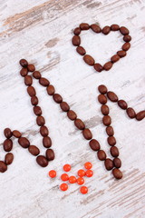 Cardiogram line of coffee grains and supplement pills, medicine and healthcare concept