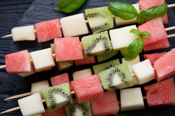 Close-up of juicy fruit kebabs, selective focus, high angle view