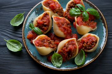 Conchiglioni baked with minced meat and tomato sauce, closeup