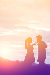 Young couple in love at sunset on the Mountain