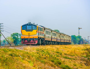Naklejka premium Passenger train was passing through rural field, 2016.