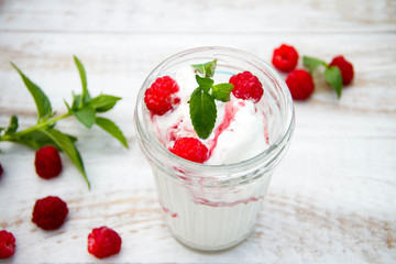 Ice cream with berries on wooden background