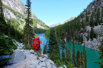 Man hiker by lake. Enchantment lakes basin near Leavenworth and Seattle, WA. 