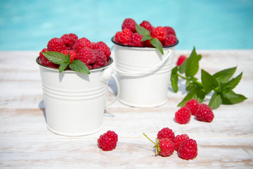 Sweet raspberries in bowl on wooden table. Close up, top view