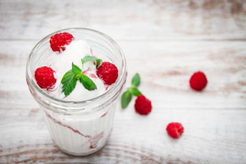 Ice cream with berries on wooden background