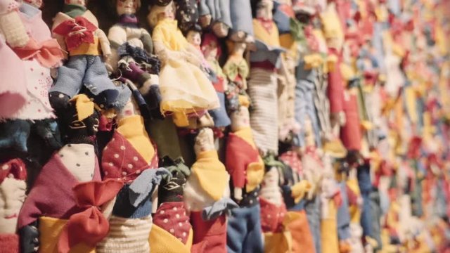Handmade dolls manufactured with colorful fabrics put them together to sell in market.