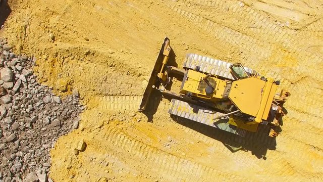 Aerial view of working bulldozer on construction site. Heavy industry, development and investment in European Union.