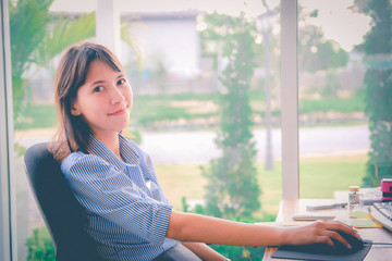beautiful young asian woman working in the office