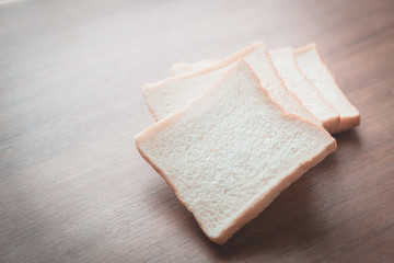 slice of bread on wooden table background