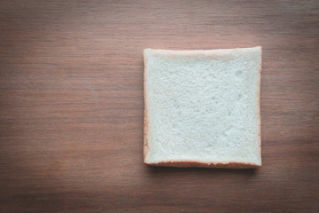 slice of bread on wooden table background