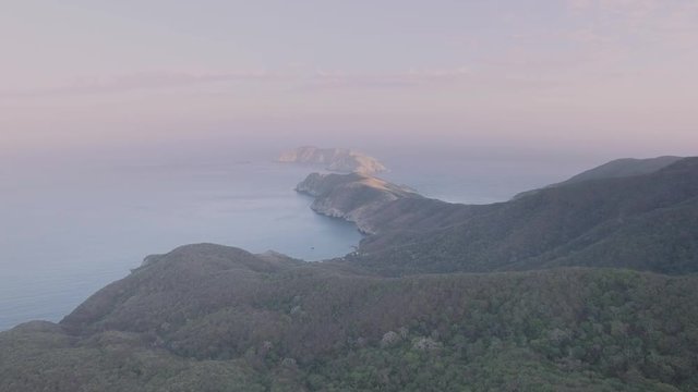 Aerial shot of green mountains descending at the caribbean, Colombia. 4k
