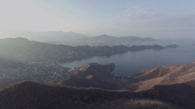 Aerial shot of green mountains descending at the caribbean, Colombia. 4k