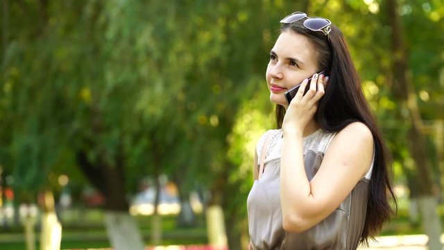 footage young woman talking on the smartphone outdoors