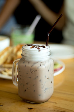 Glass of chocolate milkshake in mug vintage look