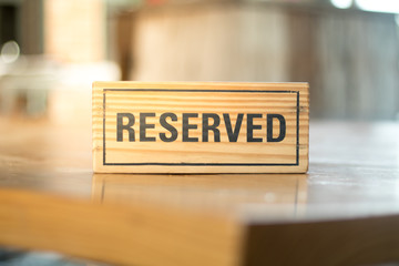 reserved sign made from wooden plate in restaurant