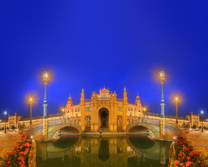 View of bridges and lights in Spain Square at evening, landmark in Renaissance Revival style, Seville, Andalusia, Spain