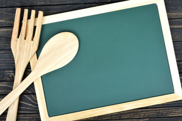Kitchen utensils and green board  on table