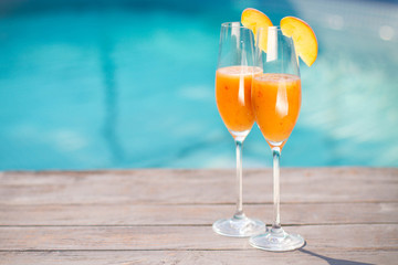 Bellini cocktail with peach isolated near pool