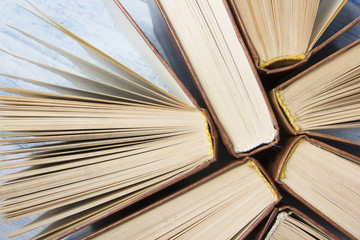 Open book, hardback books on wooden table. Back to school. Copy space for text