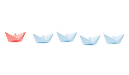 Leadership concept with blue paper ship leading among white